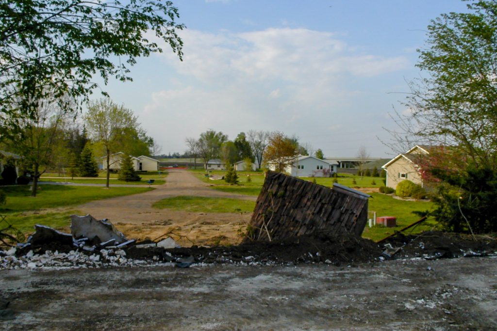 Photo by Rick Pepper - Mankato, MN - May 3, 2000 looking due north from on top of Mitchell's/Bundy's earth home straight along Ivy Lane showing various stages of removal.