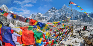 View of Mount Everest and Nuptse with buddhist prayer flags from kala patthar in Sagarmatha National Park in the Nepal Himalaya