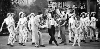 Photo courtesy Muriel Kuebler Berndt - Muriel and Barbara Kuebler in “50 Miles from Broadway,” one of the “short” pictures produced by Pathe Films to run in theaters between newsreels and the main feature. Barbara is third from the left and Muriel is to the immediate right of the tuba player.