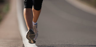 Fitness woman runner athlete running at road, working out cardio